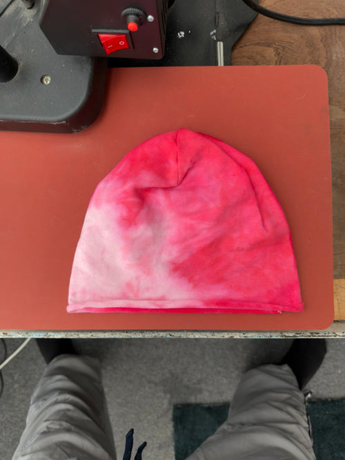 Hand-dyed beanie: pink/red with pale pink lower-left area.