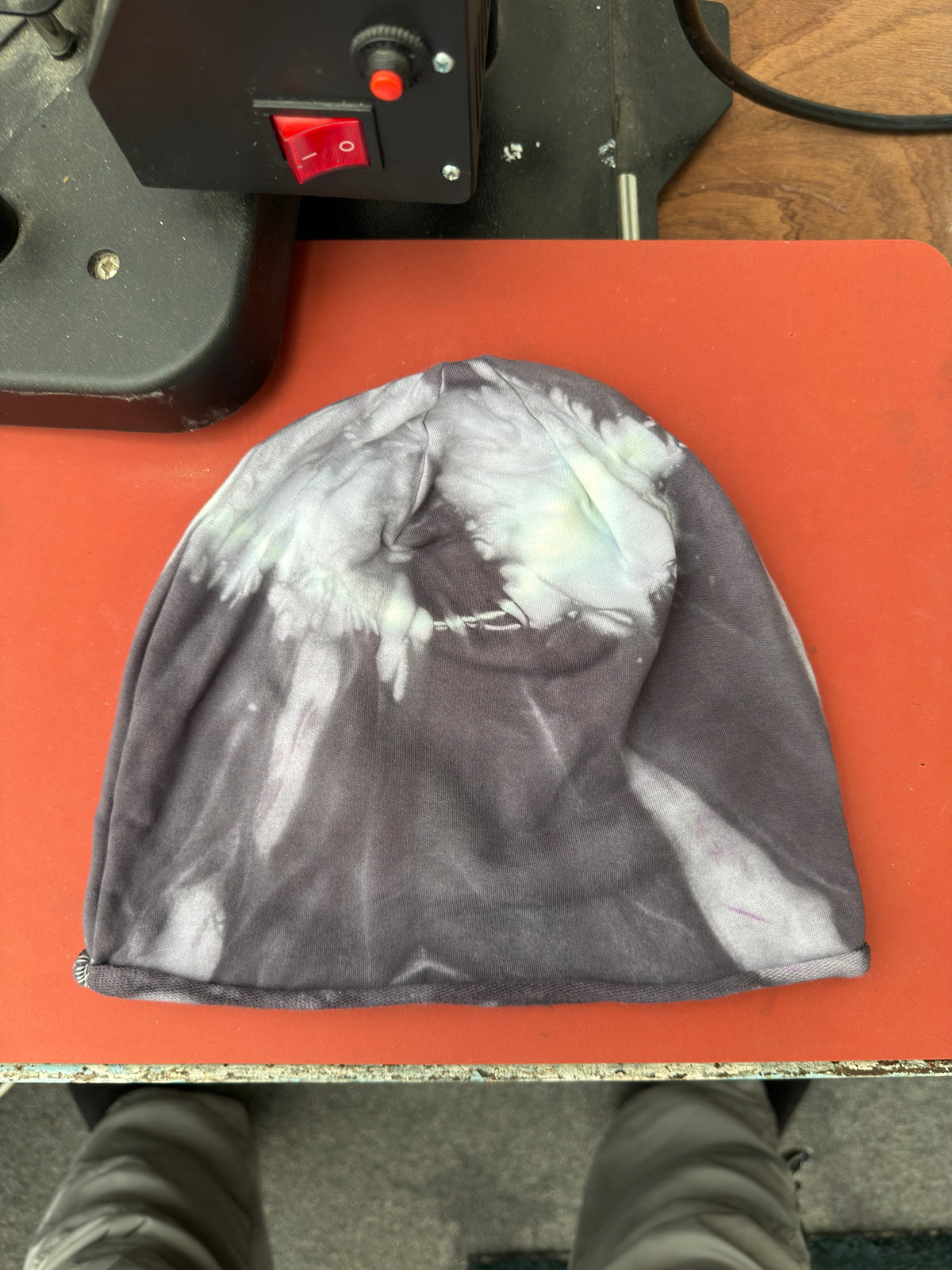 Hand-dyed beanie: charcoal grey with pale cream crown and light streaks near edges.