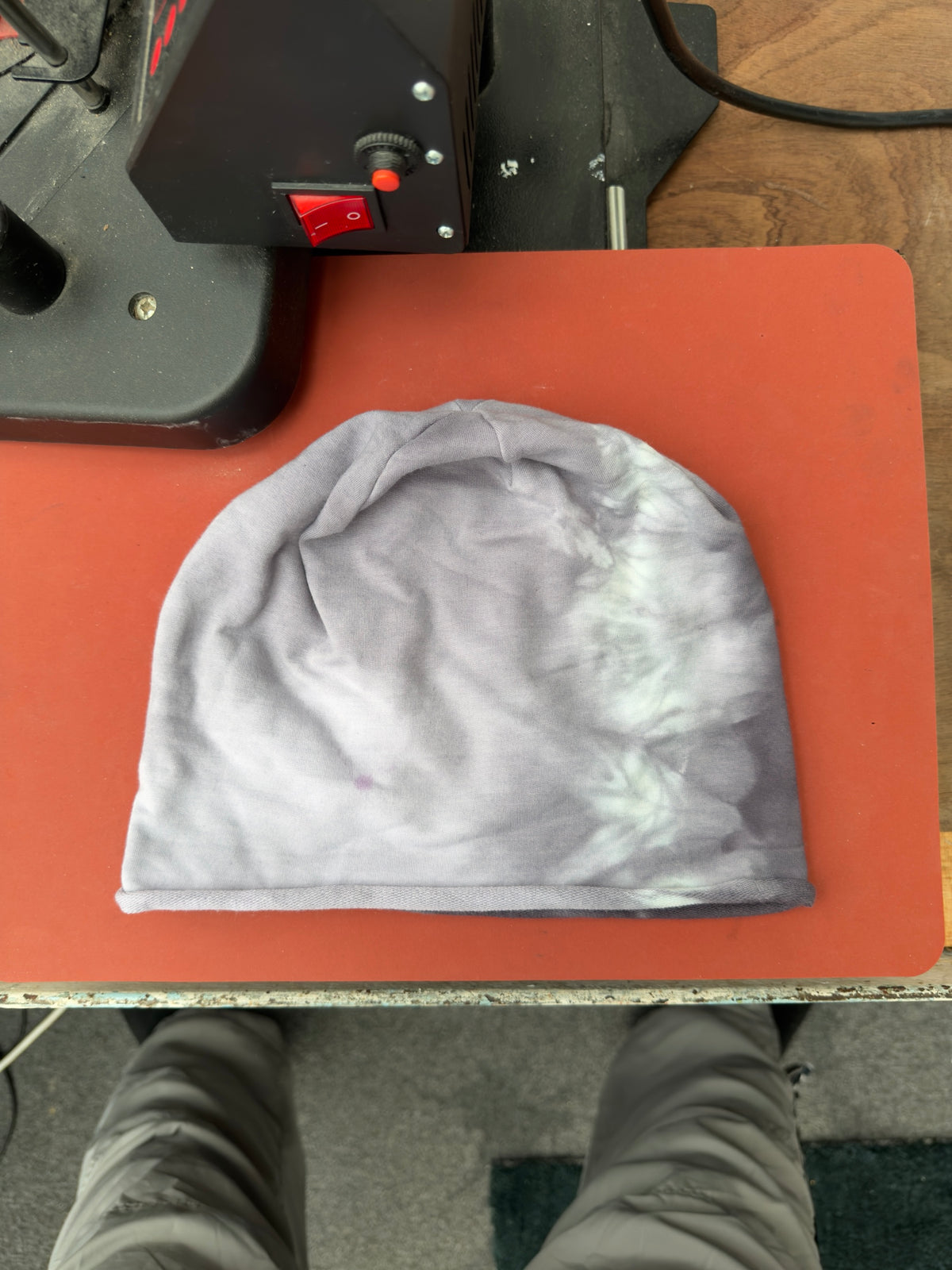 Hand-dyed beanie: soft grey with a pale cream patch along wearer-right side.