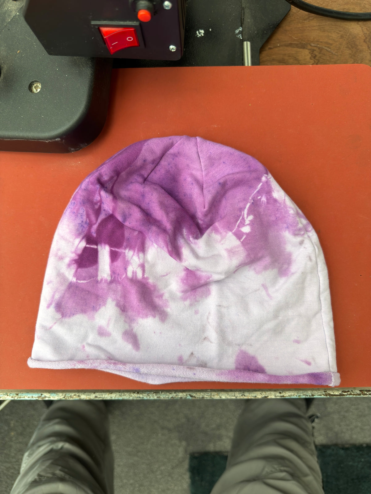 Hand-dyed beanie: purple crown/upper-left with pale lilac-white lower/right area.