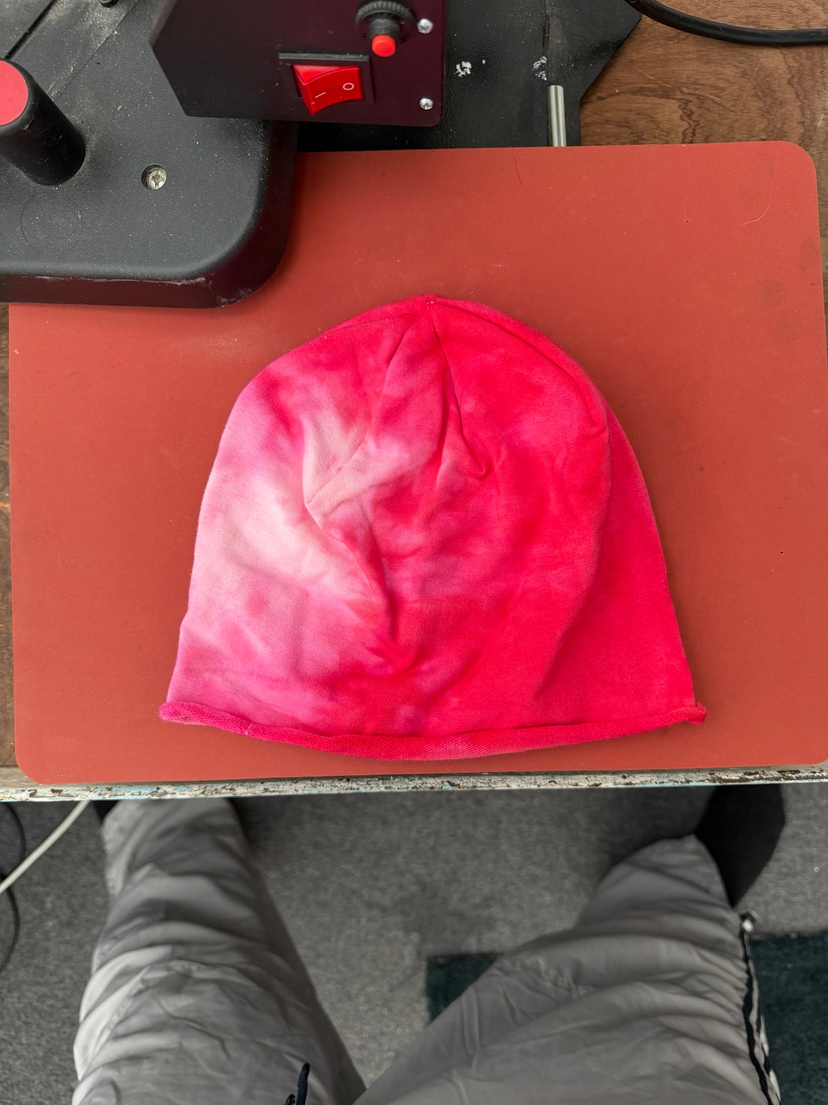 Hand-dyed red/pink beanie with pale pink branching patches across the left and centre.