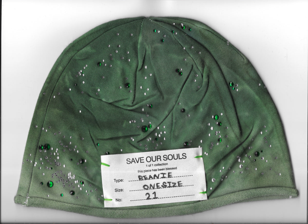 Green rhinestone beanie on a white surface with a stitched SOS label numbered 21.