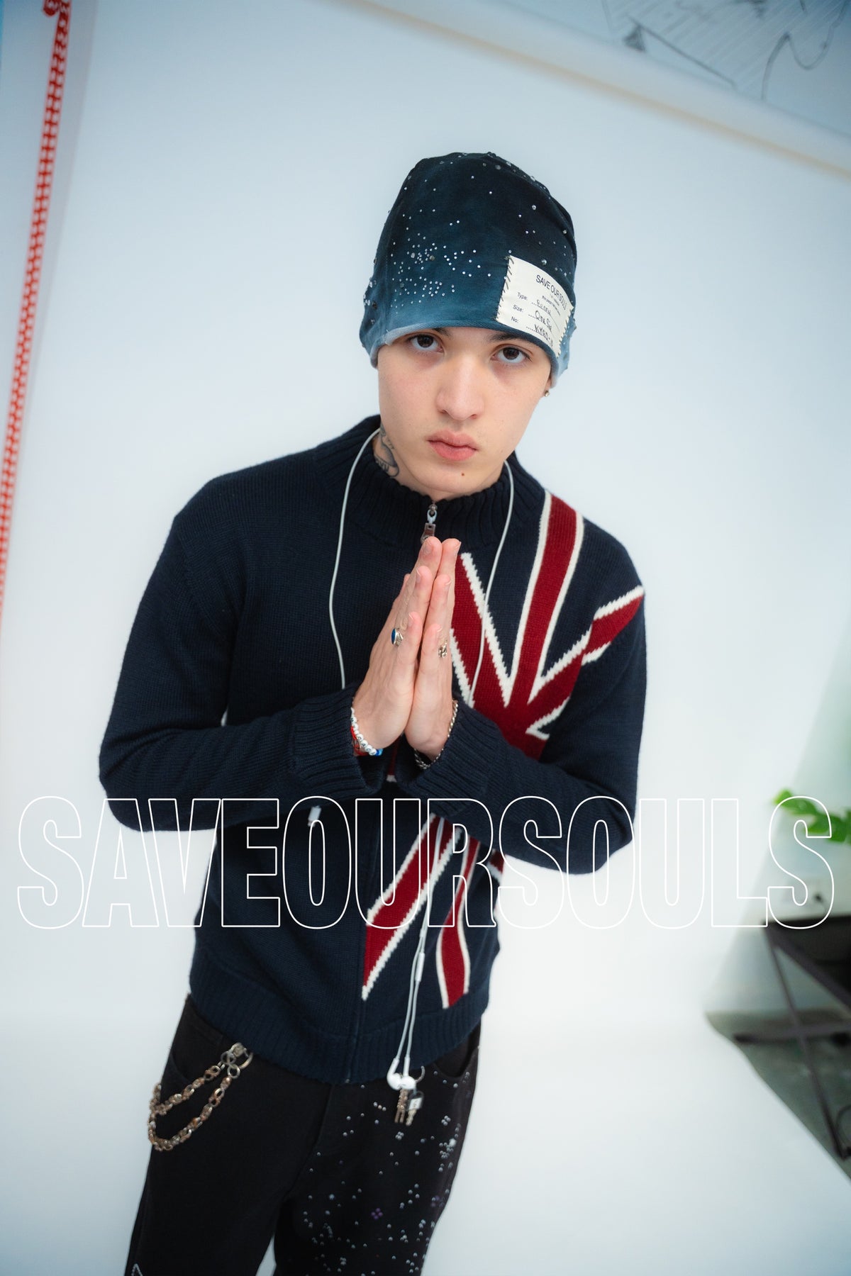 Model wearing a blue-grey rhinestone beanie beneath an outlined SAVE OUR SOULS wordmark.