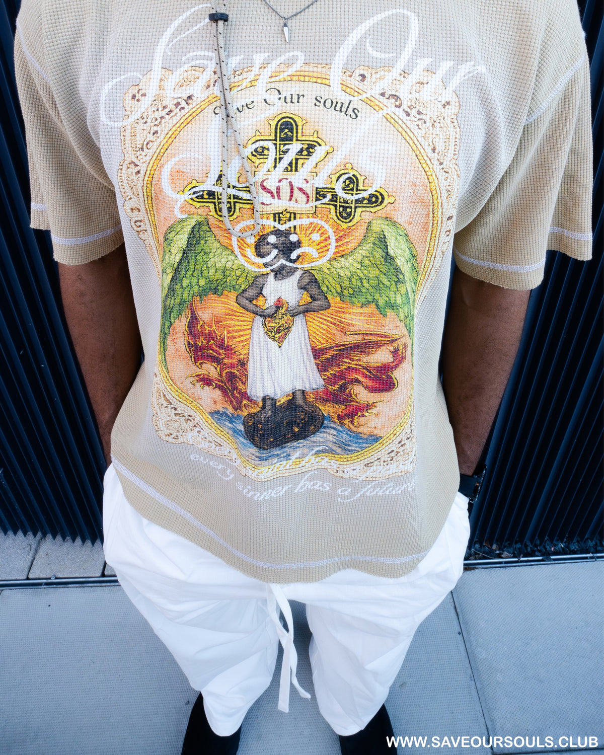 Campaign close-up photograph of the Angel artwork on a beige T-shirt.
